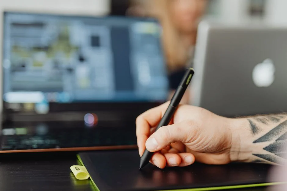 A modern office workspace featuring computers, charts, and office supplies for a productive environment.